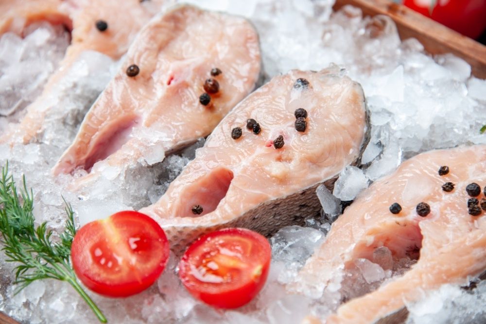 close-up-view-raw-fish-slices-with-ice-tomato-slices.jpg