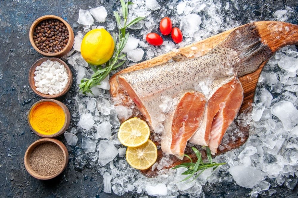 top-view-fresh-fish-slices-with-seasonings-ice-dark-background-restaurant-dinner-meal-seafood-health-meat-ocean-food.jpg